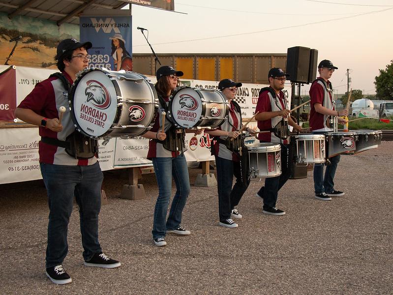 College student drum player performing outside